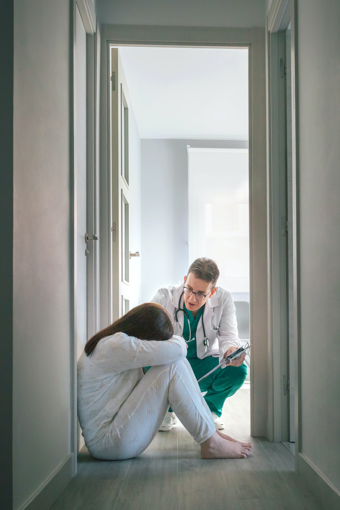 psychiatrist-talking-to-patient-sitting-on-the-floor-in-a-mental-health-center.jpg